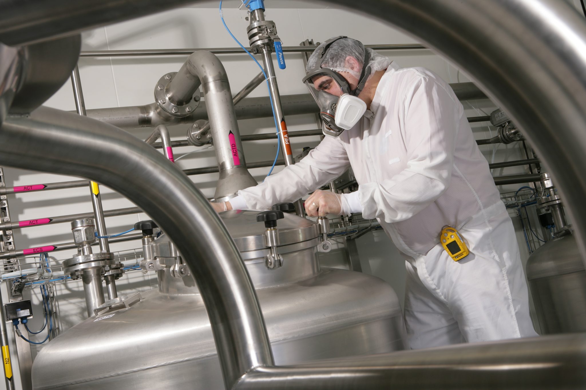 Man adjusting equipment in a manufacturing area
